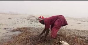 Malam Bala working on some part of his farm completely washed by flood