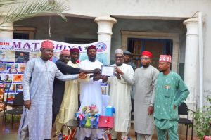 Salisu Yahaya hotoro receiving the certificate of return on behalf of Governor Yusuf 